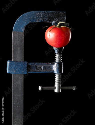 tomato squeezed by a vise