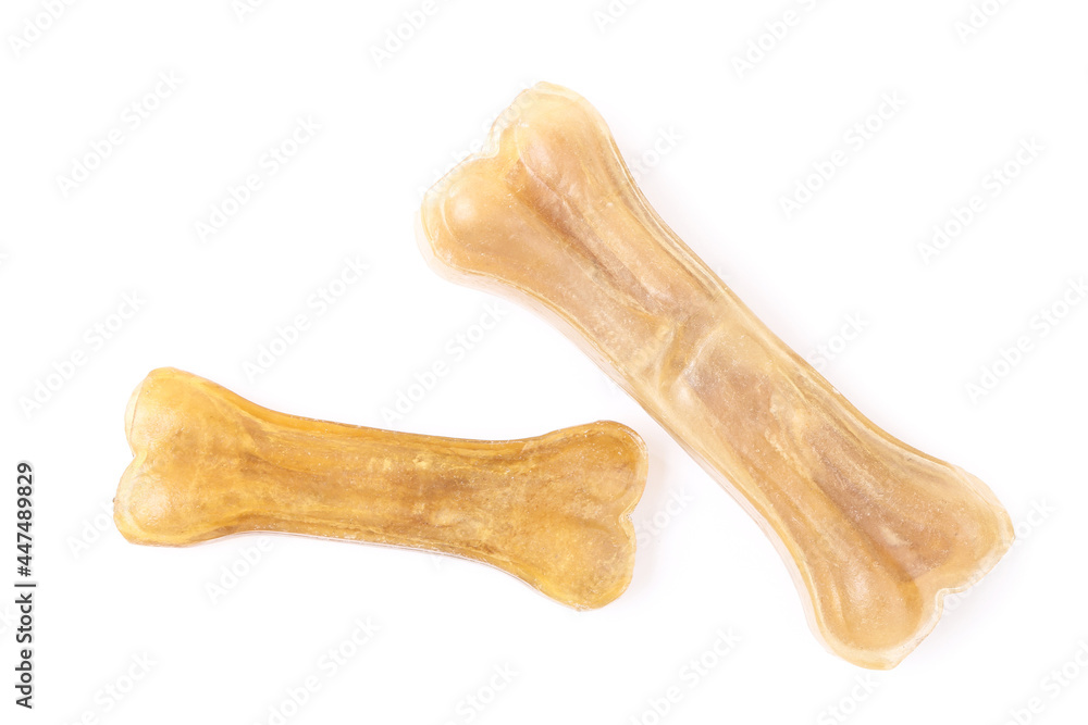 Dry pet food in shape of a bone isolated on white background Dry pet food in shape of a bone isolated on white background