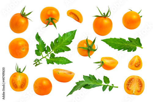 Collection of yellow orange tomatoes with green tails leaves isolated on white background. Fresh ripe Cherry tomatoes. Whole vegetables and chopped halves. Healthy vegan organic food, harvest concept