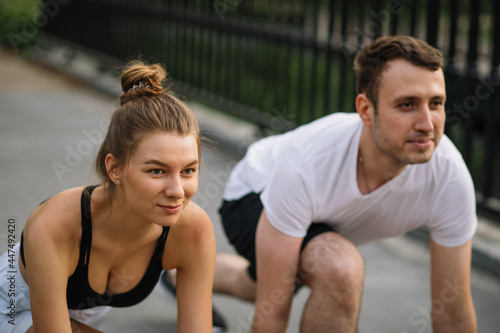 Fitness couple ready for runningin start outdoor park, in city