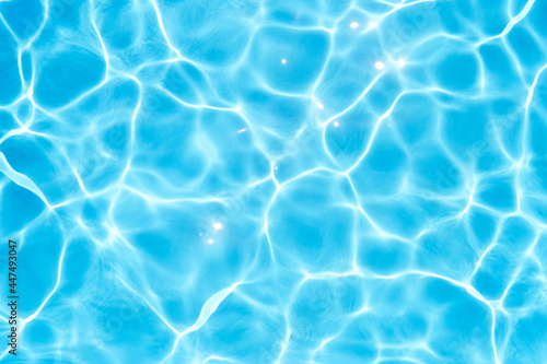 Glare on the blue water in the pool. Close-up