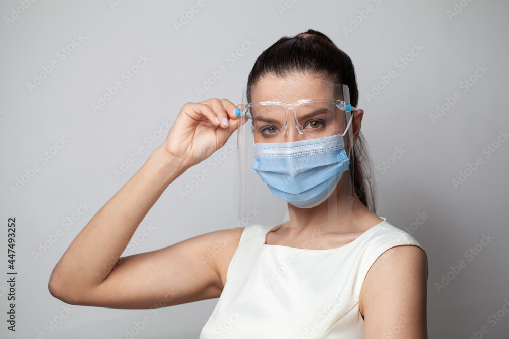 Medical practitioner woman with face shield and mask on white background Medical practitioner woman with face shield and mask on white background