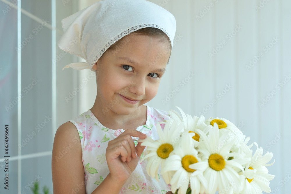 Cute little girl at home with chamomiles Cute little girl at home with chamomiles