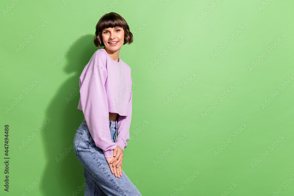 Profile side view portrait of attractive cheerful girl posing copy space isolated over bright green color background Profile side view portrait of attractive cheerful girl posing copy space isolated over bright green color background