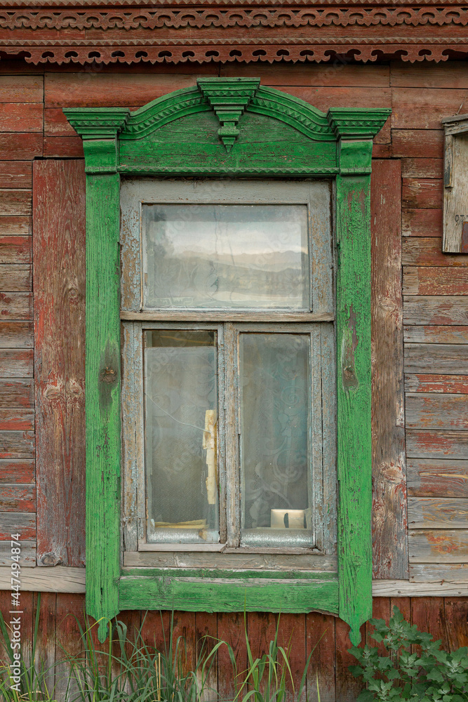 The window of an old wooden Russian house with beautiful decorative wood trims The window of an old wooden Russian house with beautiful decorative wood trims