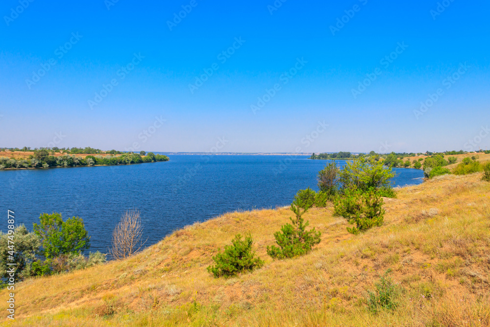 Summer landscape with beautiful river, green trees and blue sky