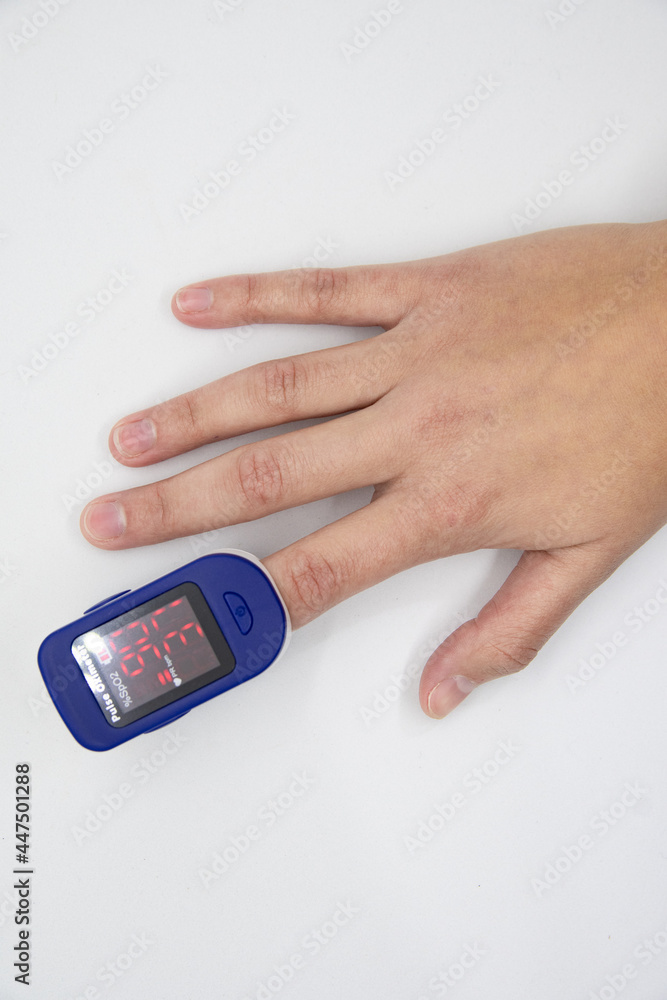 Hand using oximeter on index finger Hand using oximeter on index finger