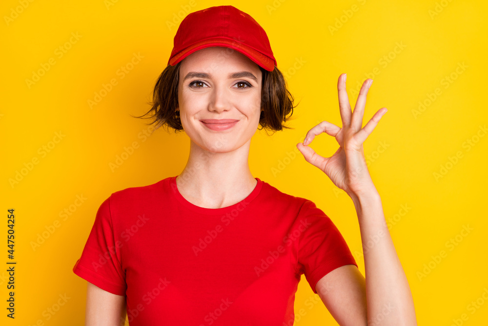 Photo of nice optimistic brown hair lady show okey wear t-shirt isolated on yellow color background Photo of nice optimistic brown hair lady show okey wear t-shirt isolated on yellow color background