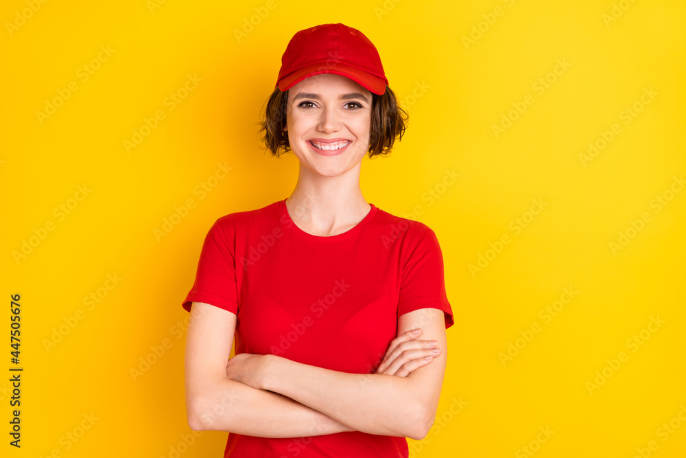 Photo of nice optimistic brown hair lady crossed arms wear t-shirt cap isolated on yellow color background Photo of nice optimistic brown hair lady crossed arms wear t-shirt cap isolated on yellow color background