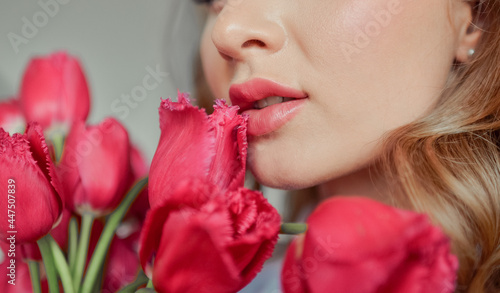 Girl with flowers. A large bouquet of pink tulips in the hands of the girl.