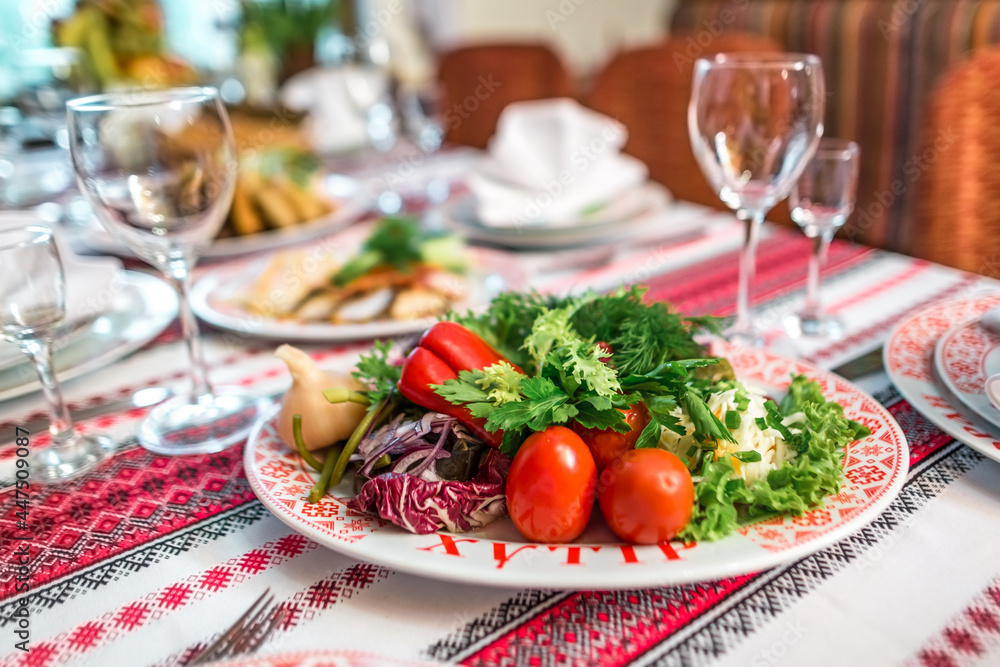 Platter with fresh and pickled vegetables on dining table Platter with fresh and pickled vegetables on dining table