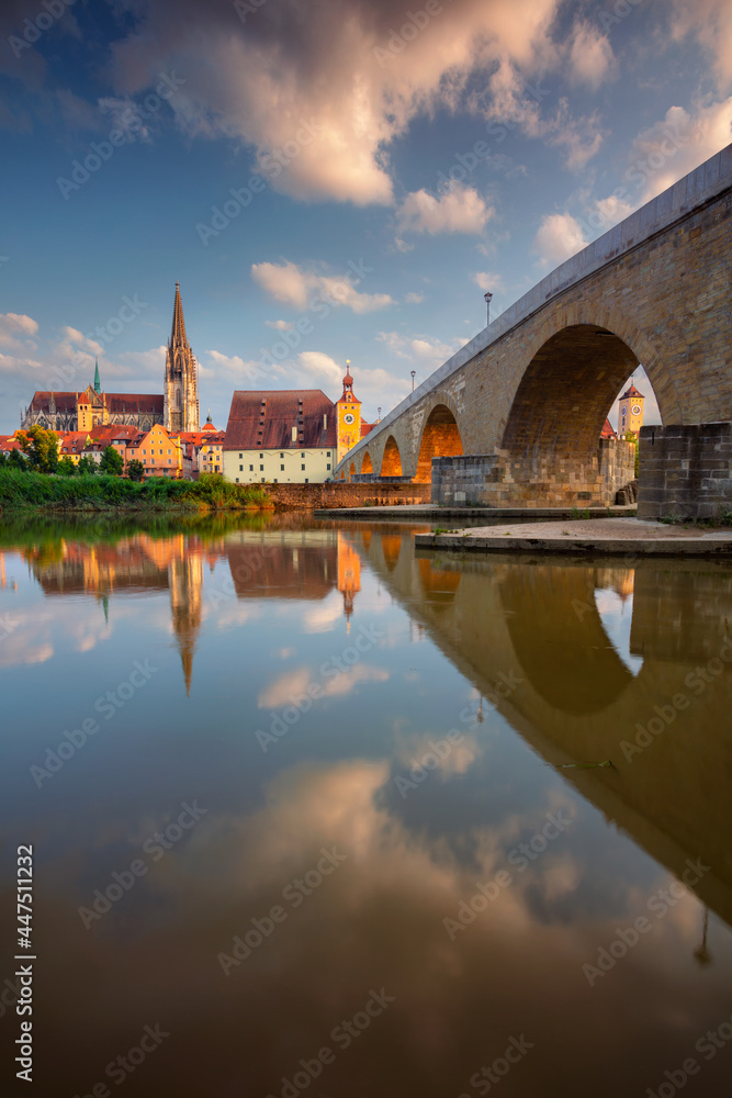 Regensburg, Germany. Cityscape image of Regensburg, Germany with Old Stone Bridge over Danube River and St. Peter Cathedral at summer sunset.