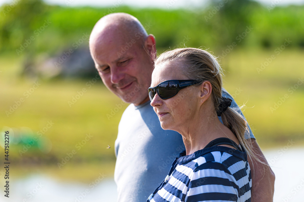 happy middle-aged couple are walking in the garden, happy relationship concept happy middle-aged couple are walking in the garden, happy relationship concept