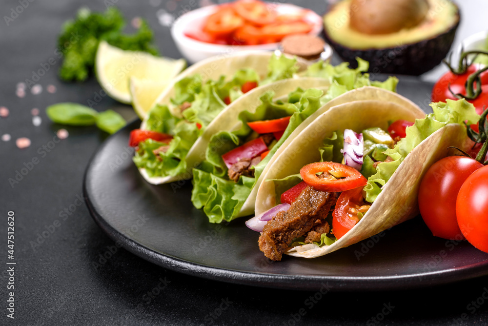 Mexican tacos with beef, tomatoes, avocado, onion and salsa sauce Mexican tacos with beef, tomatoes, avocado, onion and salsa sauce