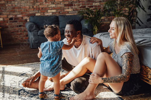 Photography Shot of young mixed race family in bedroom in daytime