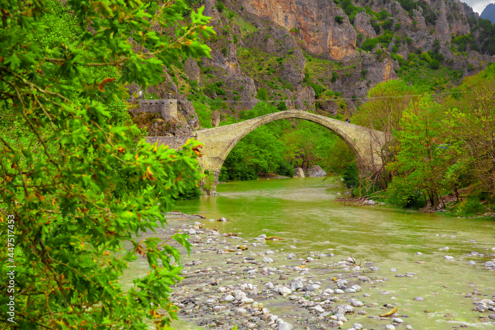 konitsa city arced bridge and voidomatis river in autumn , greece konitsa city arced bridge and voidomatis river in autumn , greece