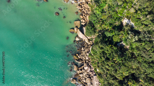 Aerial view of waves hitting rocks on a Brazilian beach coast. Balneario Camboriu