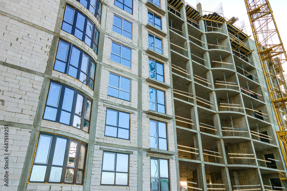 Aerial view of high residential apartment building under construction. Real estate development.