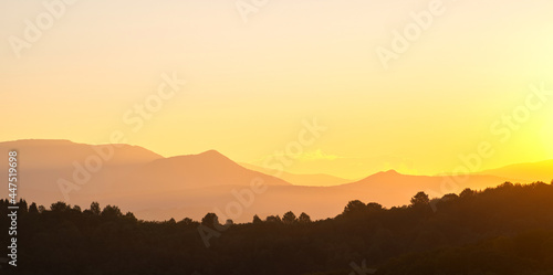 Wallpaper Mural Beautiful panoramic mountain landscape with hazy peaks and foggy valley at sunset. Torontodigital.ca