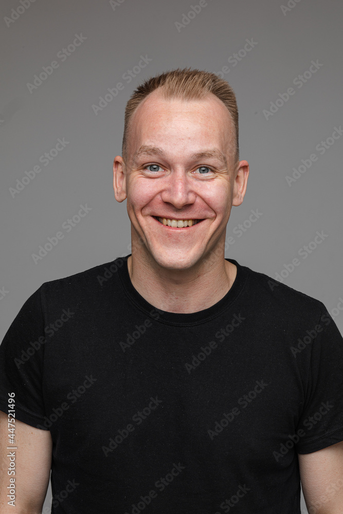 Fototapeta premium Smiling blond man in black t-shirt.