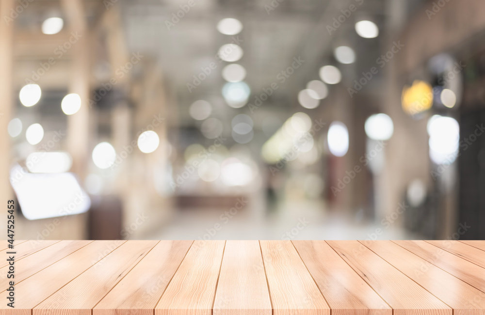 Empty wooden table top with lights bokeh on blur restaurant background. Empty wooden table top with lights bokeh on blur restaurant background.