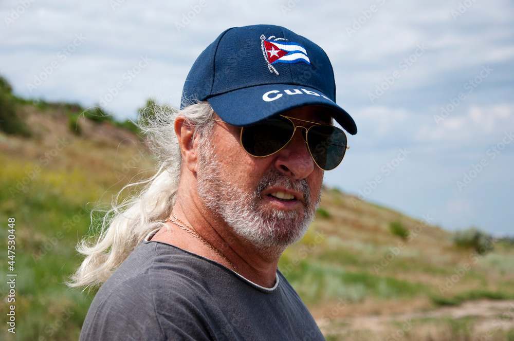 sos cuba. for a free cuba. adult male cuban revolutionary fight for liberty. old man with cuban flag sos cuba. for a free cuba. adult male cuban revolutionary fight for liberty. old man with cuban flag
