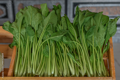 green vegetables sold in wooden boxes