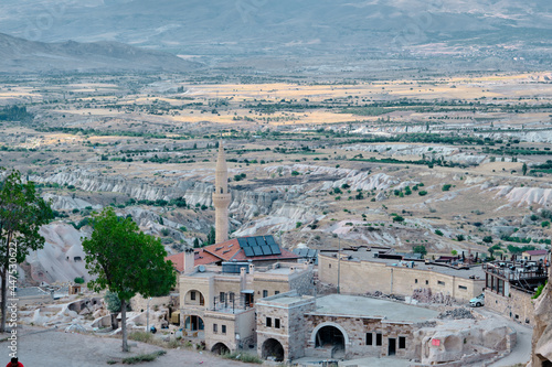 22.07.2021. Cappadocia. Nevsehir. Ancient city center of cappadocia from edge castle (uc hisar) with many magnificent houses made of special stones made of volcanic ruins and wind in many centuries. photo