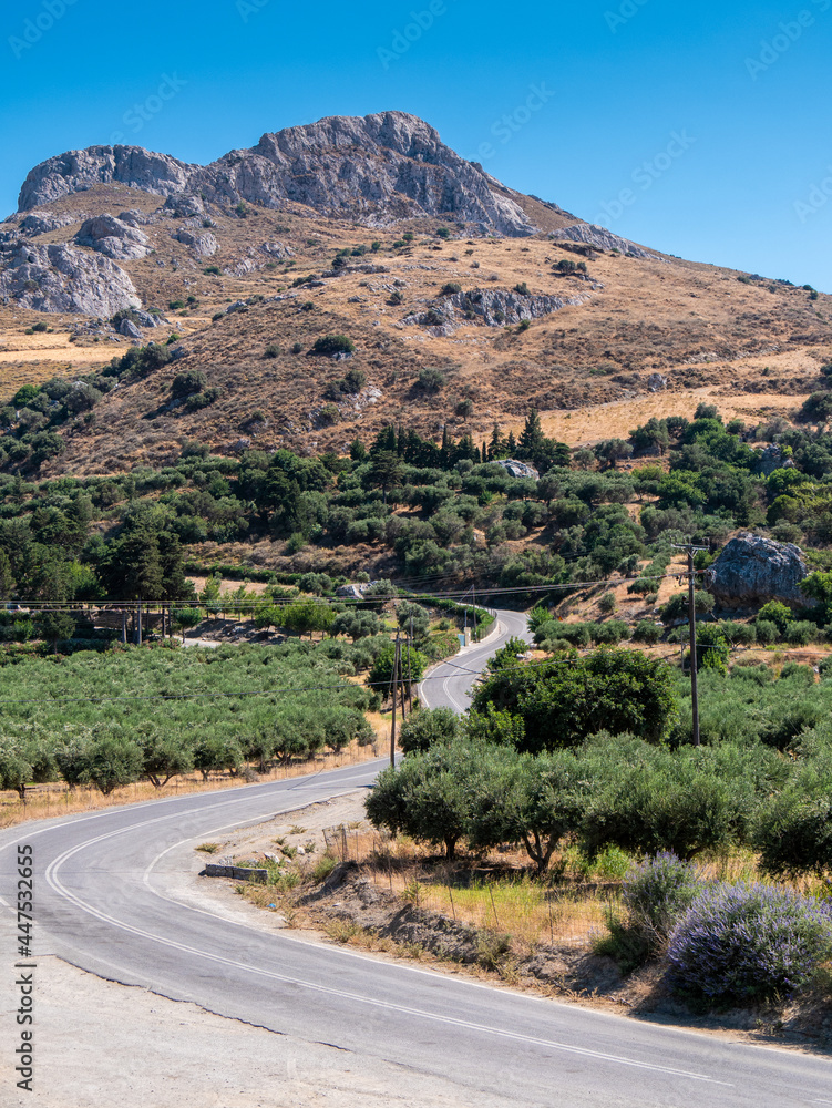 Scenic Winding Road Through Olive Groves and Rocky Hills, Crete, Greece Scenic Winding Road Through Olive Groves and Rocky Hills, Crete, Greece