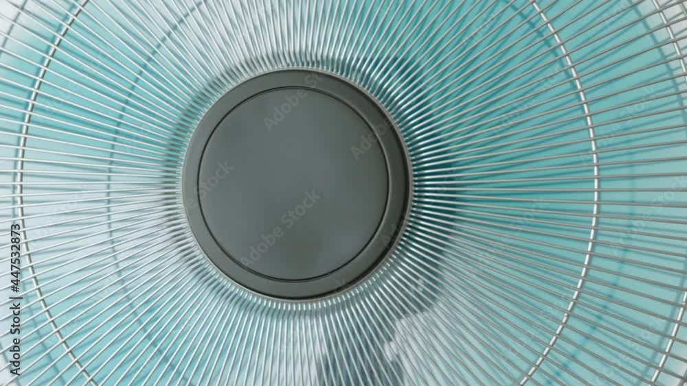 Fan spins large blades rotate slow motion against background of white