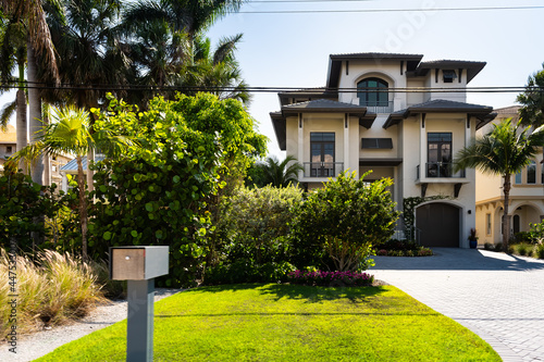 Bonita Springs, Florida gulf of mexico coast with mailbox at luxury villa mansion house modern waterfront architecture and driveway to garage © Andriy Blokhin