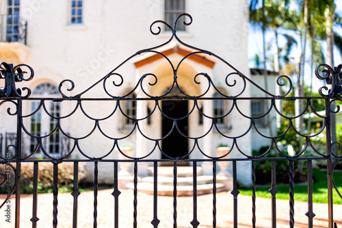 Hollywood, Florida in Broward County city in North Miami Beach area with entrance metal gate fence and background of luxury house mansion near the beach photo