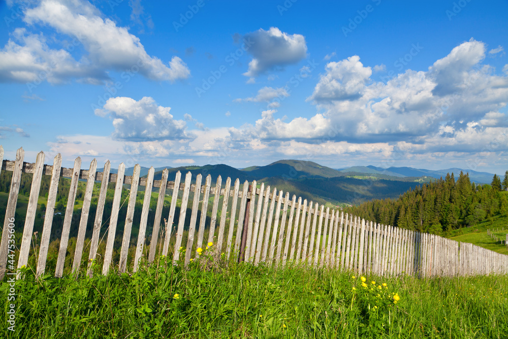 Wooden fence on top of mountains, bright blue sky. Ukraine, Carpathians. Wooden fence on top of mountains, bright blue sky. Ukraine, Carpathians.
