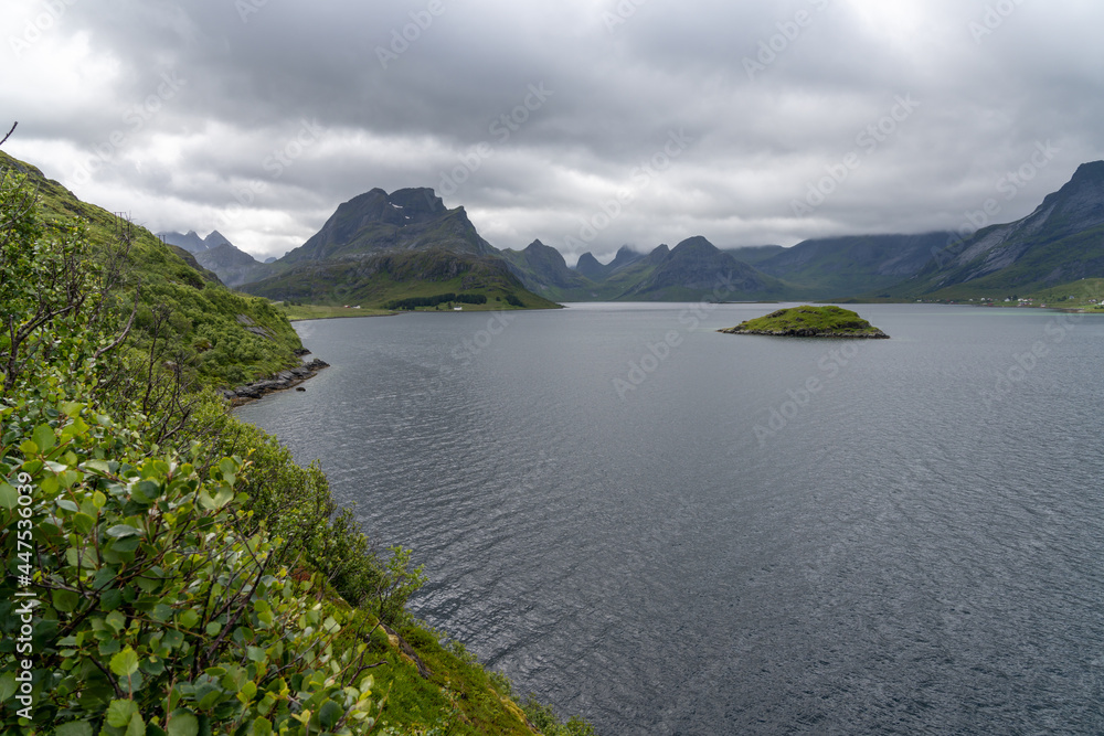 view of the Lofoten Islands in northern Norway under an overcast and cloudy sky with a view of the Selfjorden