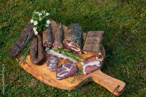 Selection of traditional handmade Corsican specialities with finely sliced cold cuts of coppa, wild boar sausage, Figatellu, Lonzu and Pancetta.	 photo