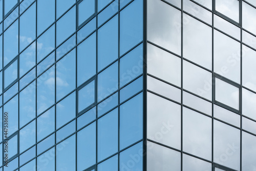 Abstract image of the facade of a modern high rise building covered in reflective plate glass