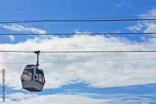 Cable car of the city of Santo Domingo in Dominican Republic, behind the blue sky and clouds