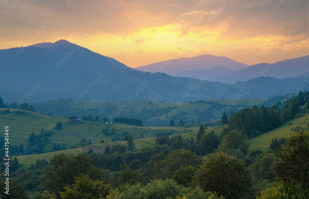 Fototapeta premium The ridgeline of Carpathian mountains in dusk sunlight. Wide-angle mountain range landscape.