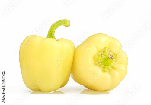 Two yellow bell peppers isolated on white background. Shiny paprika