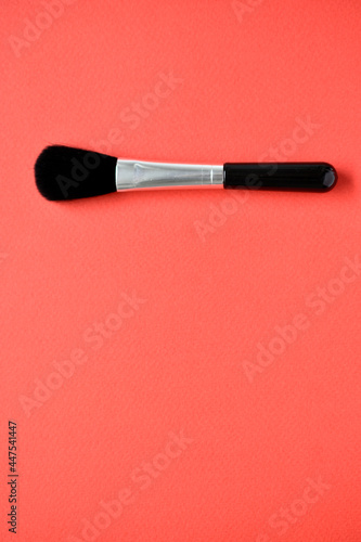 Brush for cleaning optics on a red background