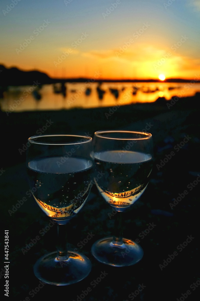 Beautiful harbour sunset with wine glasses