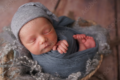 Sleeping newborn boy in the first days of life. Newborn photo session.