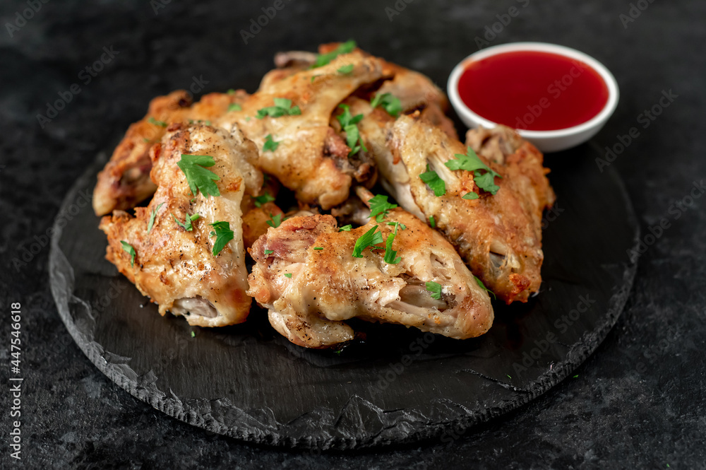 grilled chicken wings on stone background