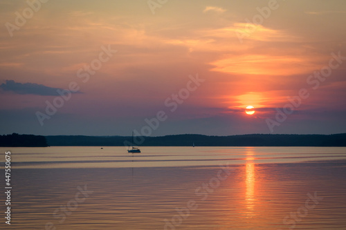 The orange sunset and the sail over the Minsk sea  Belarus