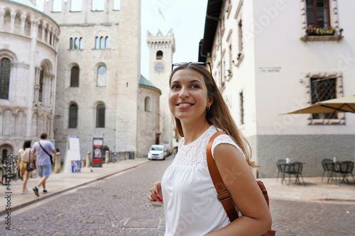 Happy tourist woman visiting the old medieval town of Trento, Italy