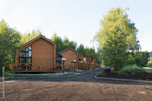 Fototapeta Naklejka Na Ścianę i Meble -  Barnhouse style houses. A street with cozy small houses. Modern construction
