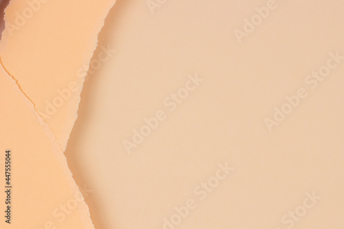 Two pieces of torn paper on blank beige paper background. Abstact monochrome earthy color background