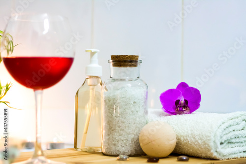 Spa-beauty salon  wellness center. Spa treatment aromatherapy for the female body in the bathroom with a glass of wine  with candles  oils and salt