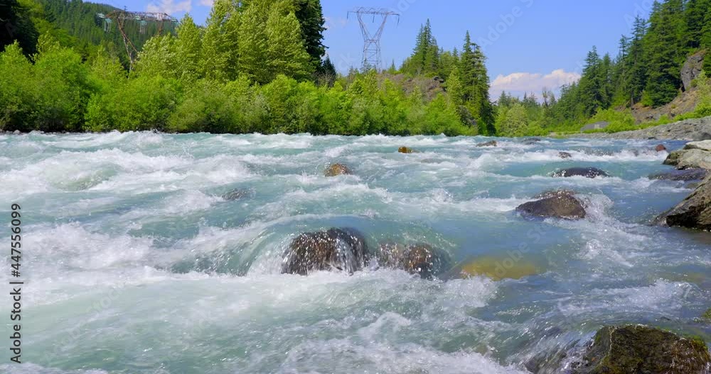 Establishing shot of majestic mountain creek with rocky background in Vancouver, Canada, North America. Day time on June 2021. Still camera view. ProRes 422 HQ. Establishing shot of majestic mountain creek with rocky background in Vancouver, Canada, North America. Day time on June 2021. Still camera view. ProRes 422 HQ.