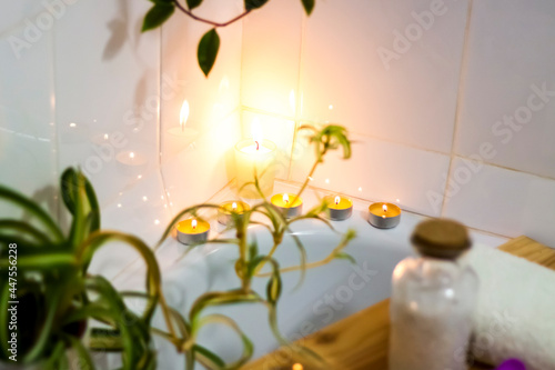 Spa-beauty salon  wellness center. Spa treatment aromatherapy for a woman s body in the bathroom with candles  oils and salt.